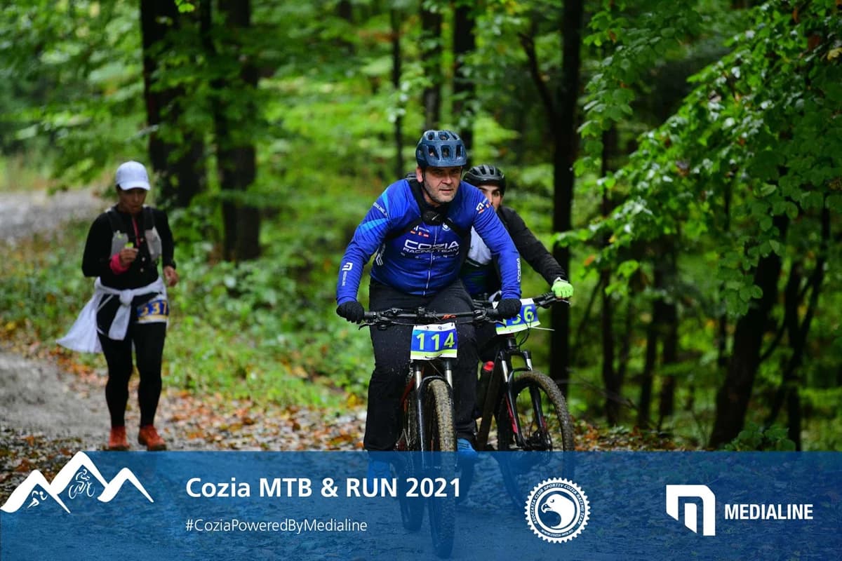 XCM marathon riders on a forest road at the foot of the Cozia massif — Vâlcea, Romania