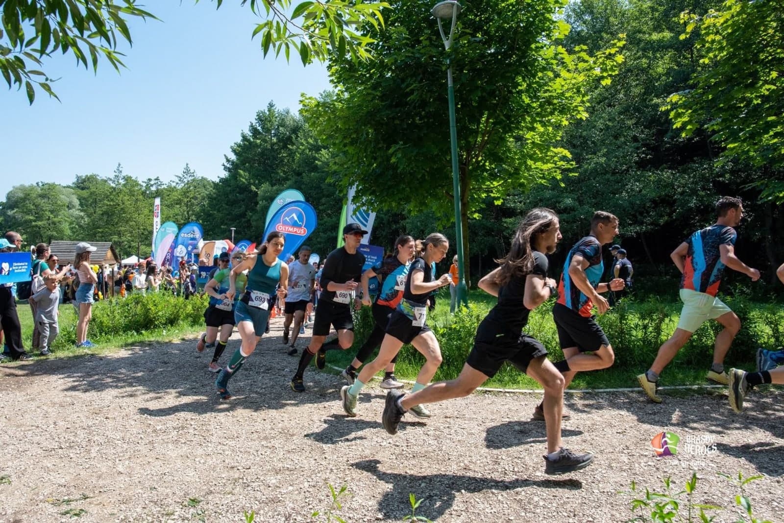 Runners tackling obstacles at the Brasov Heroes charity race by Lacul Noua lake